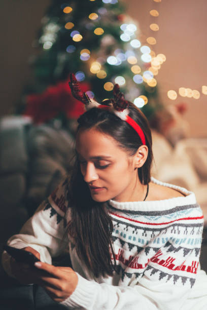 istock Woman Using Phone At Christmas 1190681133