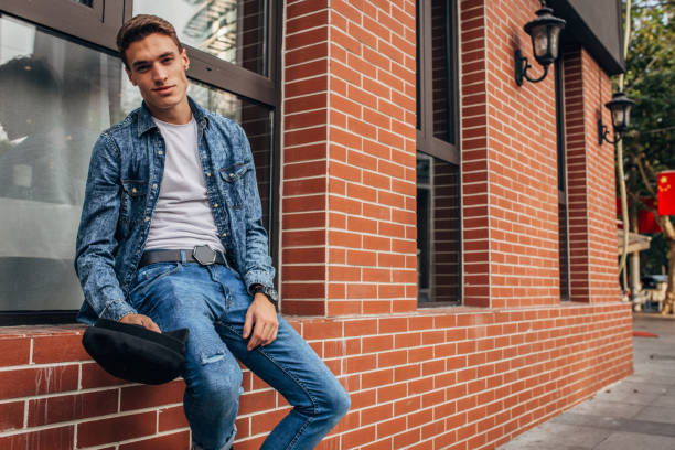 istock Handsome young man sitting by the window 1190681963