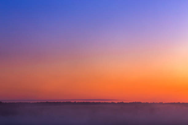 minmalistic foggy sky glow before sunrise without sun.