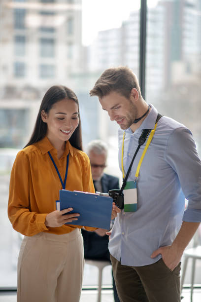 istock Female dark-haired reporter sharing her thoughts with her colleague 1190685077
