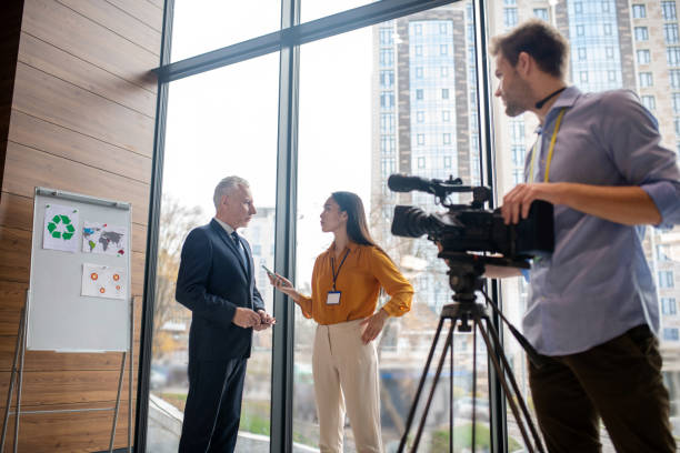 istock Male video operator looking at his colleague 1190685081