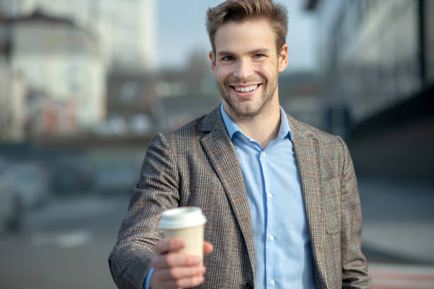 istock Young handsome man in a jacket smiling positively 1190685767