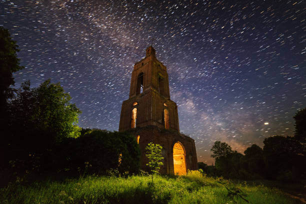 istock night bell tower ruin in forest at starry night with internal light 1190685922
