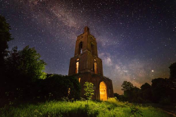 istock night bell tower ruin in forest at starry night with internal light 1190685932