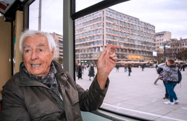istock Old man traveling in city bus 1190685947