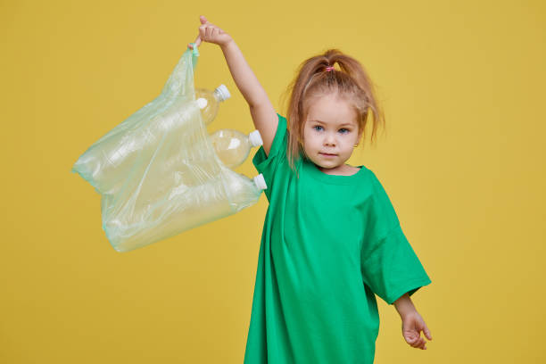 istock Little girl is separate plastic trash to recycle 1190686552