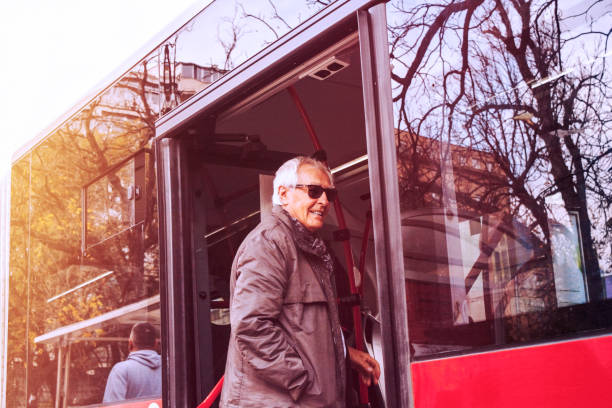 istock Old man using on bus door in public city transport 1190687789