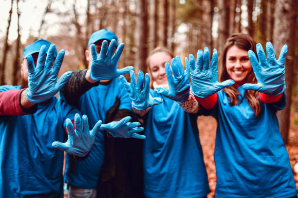 istock Happy Volunteers Showing Their Working Gloves 1190689967