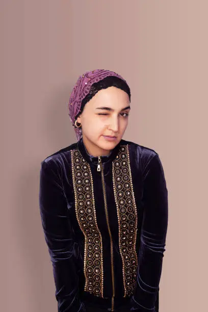 Portrait of an elegant Iranian woman. Middle-eastern woman with a headscarf. A Muslim woman from Central-Asia wearing traditional clothing. Isolated stock image