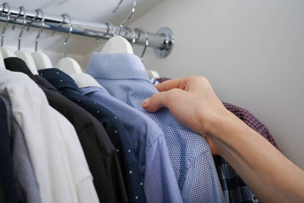 istock A man's hand takes a shirt on a hanger 1190692180