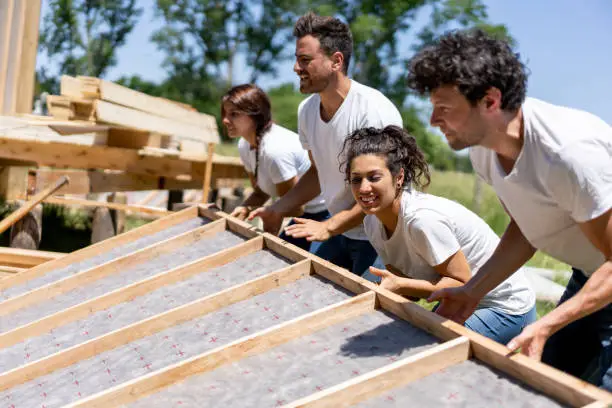 Photo of Latin american volunteers working hard at a charity construction project