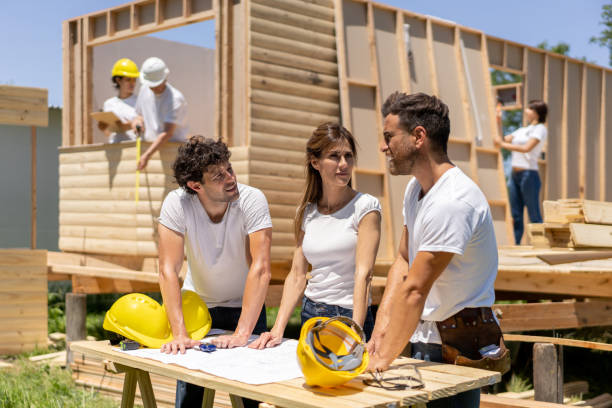 istock Foreman discussing costruction project with volunteers while looking at blueprint 1190692691