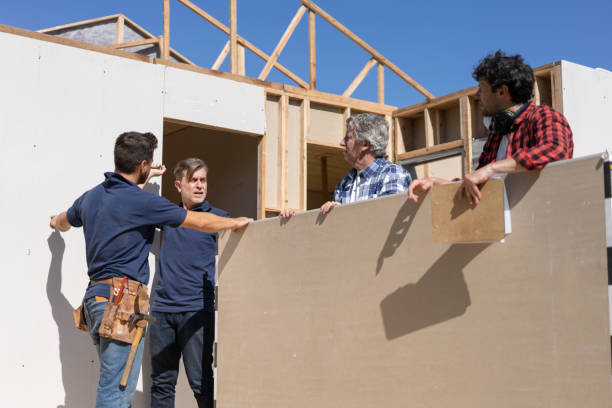 istock Construction team getting the board panels ready to install on frame at a construction site 1190692734