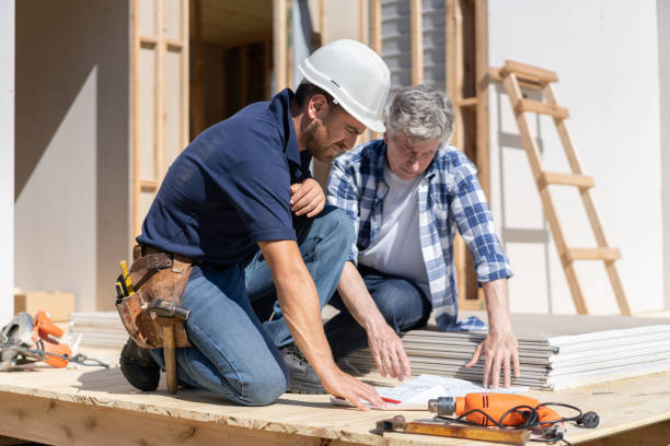 istock Architect and engineer checking out the blueprint sitting on floor at contruction site 1190692742