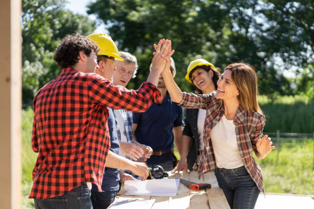 istock Construction contractors during a meeting celebrating something with a high five at the construction site 1190692755