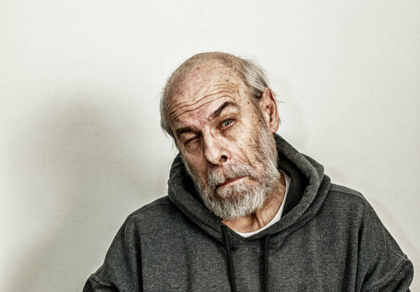Headshot of old man with wrinkled face indoor home close up