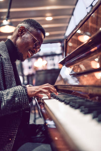 Handsome African Male Entertaining People By Playing Piano