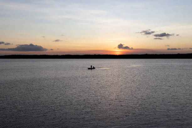 Silhouette of a boat during the sunset at river Jacaré, in João Pessoa, Brazil