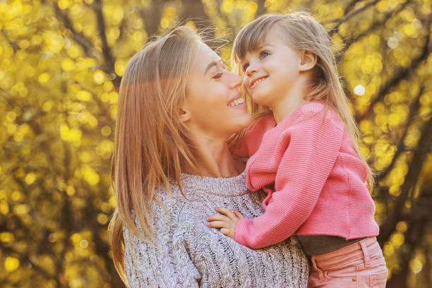 istock Mom and daughter having fun outdoors and hugging 1190699391