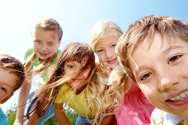istock Group of smiling children leaning into camera 119069954