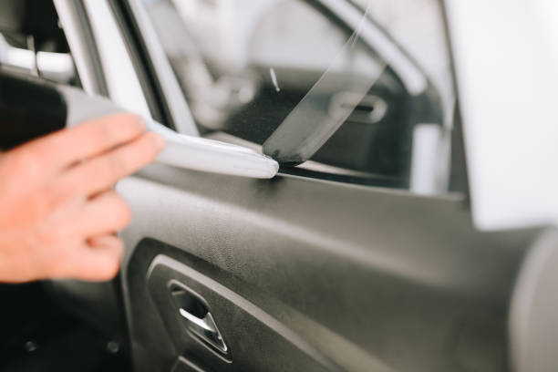 istock Man cleans car interior with vacuum cleaner 1190699904