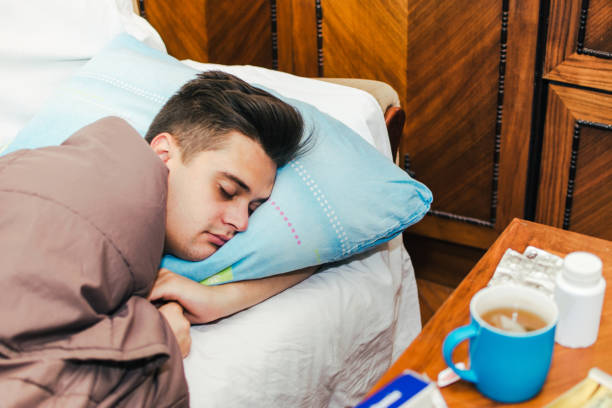 istock Sick man in bed stock photo 1190700530