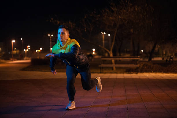 istock Strong man exercising at night 1190704226