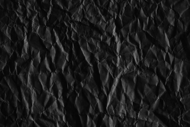 istock Dark black blank paper backgrounds creased crumpled surface old torn ripped posters grunge textures placard 1190704974