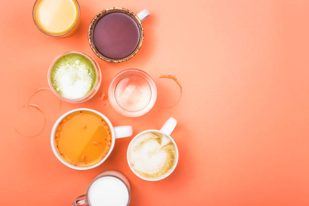 Cups of coffee, tea, juice and water. Morning drinks for different preferences. Top view.