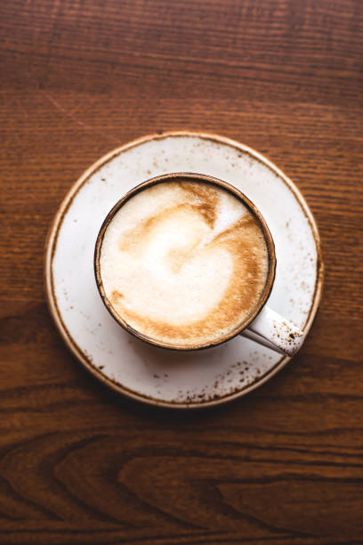 istock Beautiful cappuccino with art in a white cup. Top view, close up. 1190705058