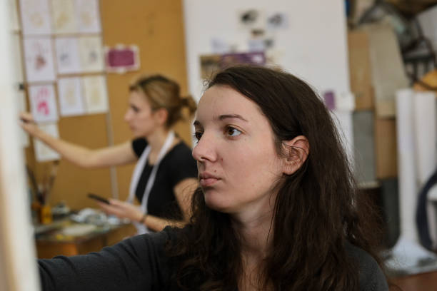 istock Two young girls painting in an Art studio 1190707620