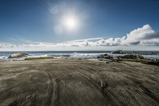 Empty sand beach with tyre tracks against sky, carmel beach,California,USA.