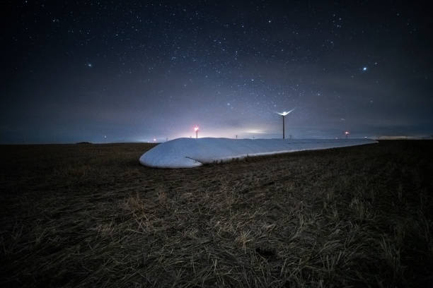 istock milky way over wind turbines 1190714597