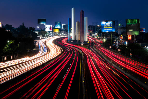 Naucalpan, State of Mexico, Mexico, May 11, 2019 multilane road with car lights in the blue hour cityscape with bright light streaks in front of satellite towers in Naucalpan mexico state photos stock pictures, royalty-free photos & images