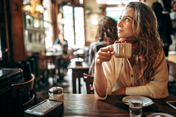 istock Woman drinking coffee at cafe 1190729247