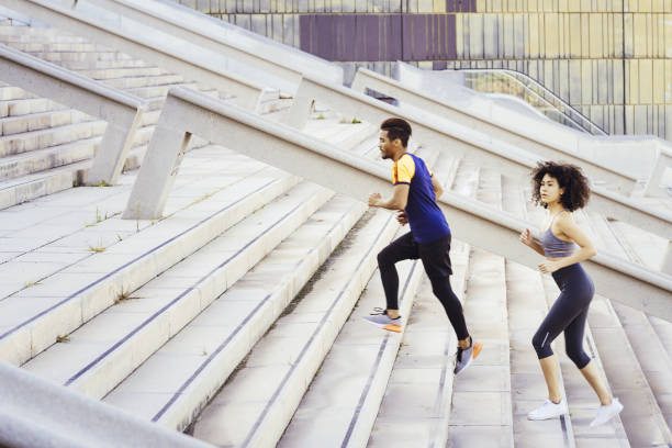 istock interracial couple training running up stairs 1190734162