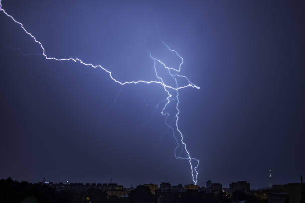istock Bright lightning in the black sky over the city 1190734442