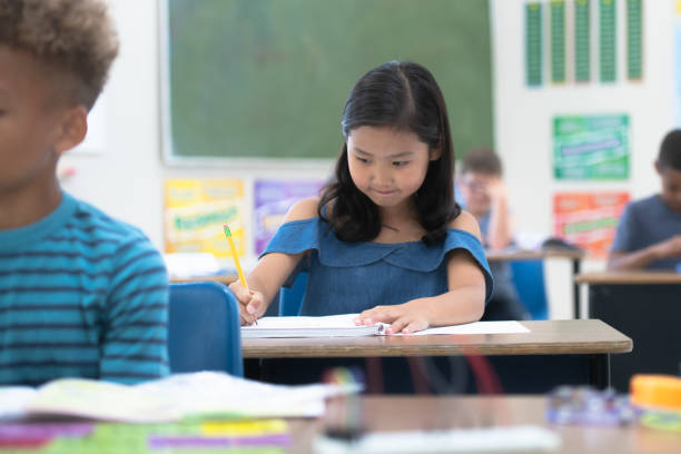 istock Asian Elementary Student Working on Writing stock photo 1190740910
