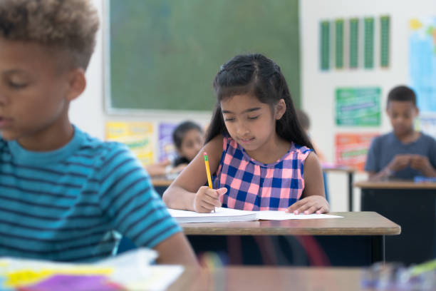 istock East Indian Elementary Student Working on Writing stock photo 1190740942