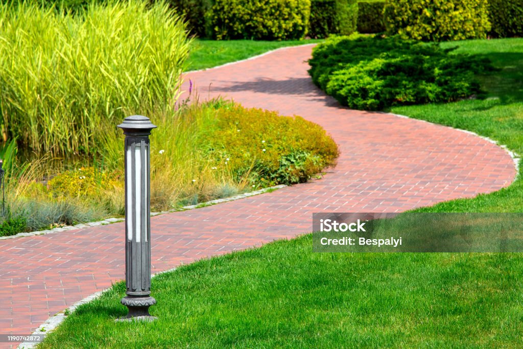 Lighting Ground Lamp Street Mounted On A Green Lawn In A Park With