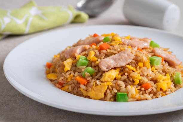 istock Fried rice chicken with egg and vegetables on white plate 1190743904