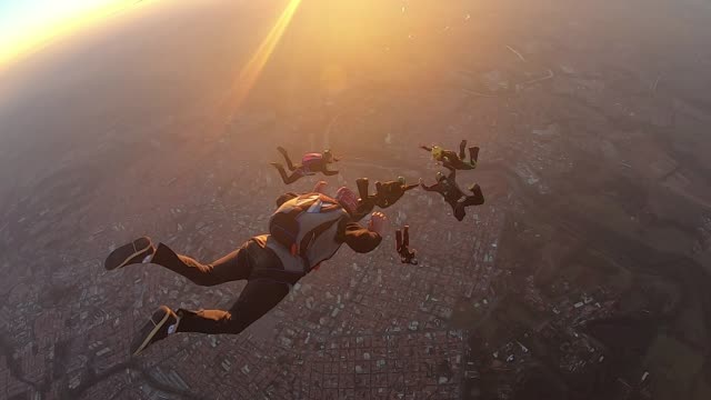 Skydivers jump at the awesome sunset