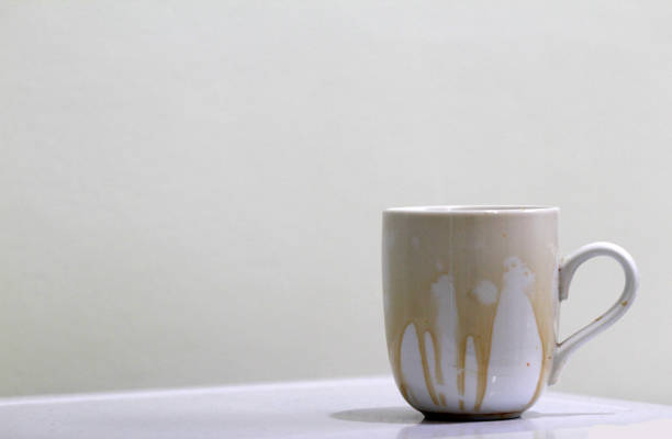 istock Coffee stain on  white coffee cup with white background and free space for text 1190746770