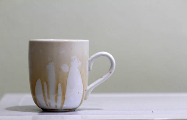 istock Coffee stain on  white coffee cup with white background and free space for text 1190746785