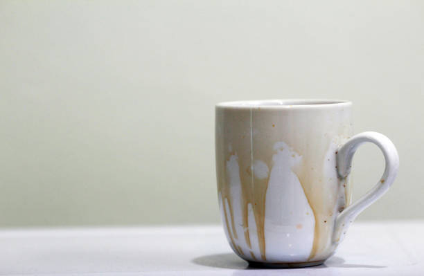 istock Coffee stain on  white coffee cup with white background and free space for text 1190746786