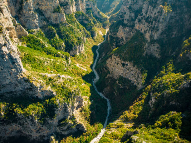 Vikos Gorge, a gorge in the Pindus Mountains of northern Greece, lying on the southern slopes of Mount Tymfi, one of the deepest gorges in the world. Aerial view of Vikos Gorge, a gorge in the Pindus Mountains of northern Greece, lying on the southern slopes of Mount Tymfi, one of the deepest gorges in the world. Zagori region, Greece. zagori stock pictures, royalty-free photos & images