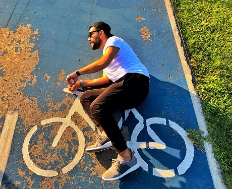 Man lying on the road with bicycle symbol