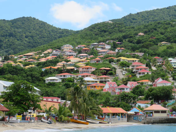 Panoramic view of the small coastal town of Anses d'arlet. Colored houses on hill with abundant vegetation.  Martinique in French West Indies. Antilles. Caribbean landscape Panoramic view of the small coastal town of Anses d'arlet. Colored houses on hill with abundant vegetation.  Martinique in French West Indies. Antilles. Caribbean landscape french overseas territory stock pictures, royalty-free photos & images