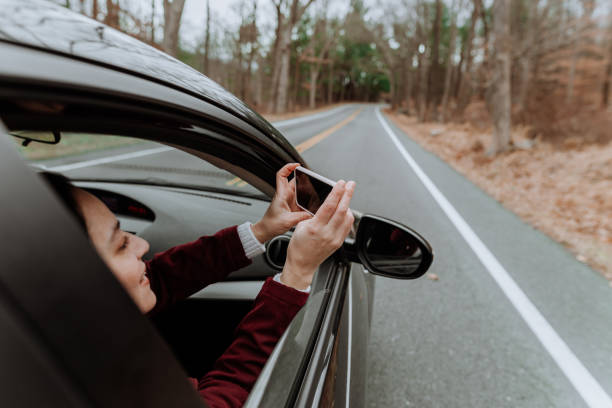 istock Woman taking pictures inside the car 1190762242