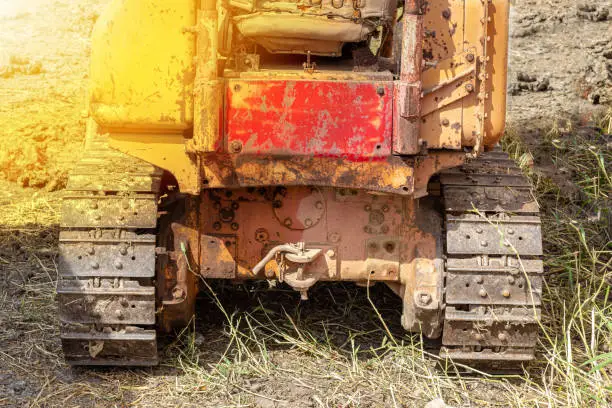 Old yellow-tone tracked tractors, heavy-duty
